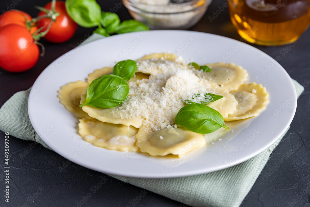 Ravioli with ricotta, spinach and basil in a white plate Ravioli with ricotta, spinach and basil in a white plate
