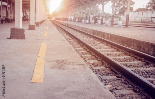 Old and unrepaired yellow warning line at a train station.focusing on the yellow line. photo