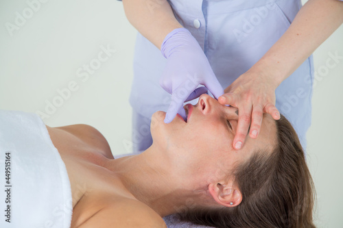 Professional buccal or internal massage of the girl's face