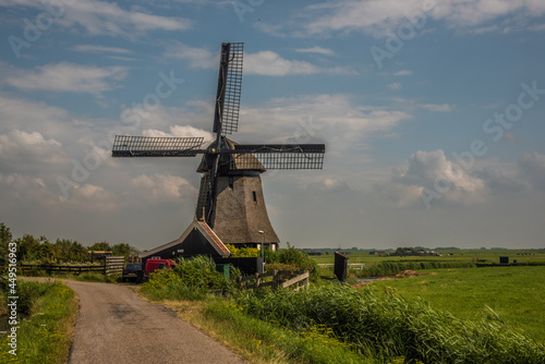 Schoorl, the Netherlands. July 2021. Dutch landscape with windmill and thatched roof.