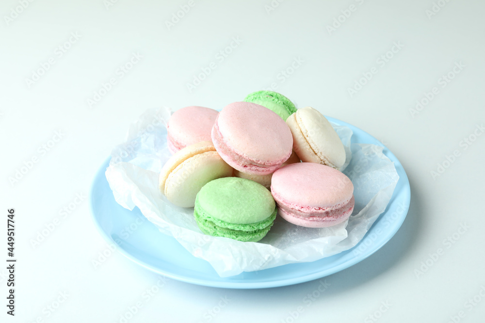 Concept of tasty dessert with macaroons on white background Concept of tasty dessert with macaroons on white background