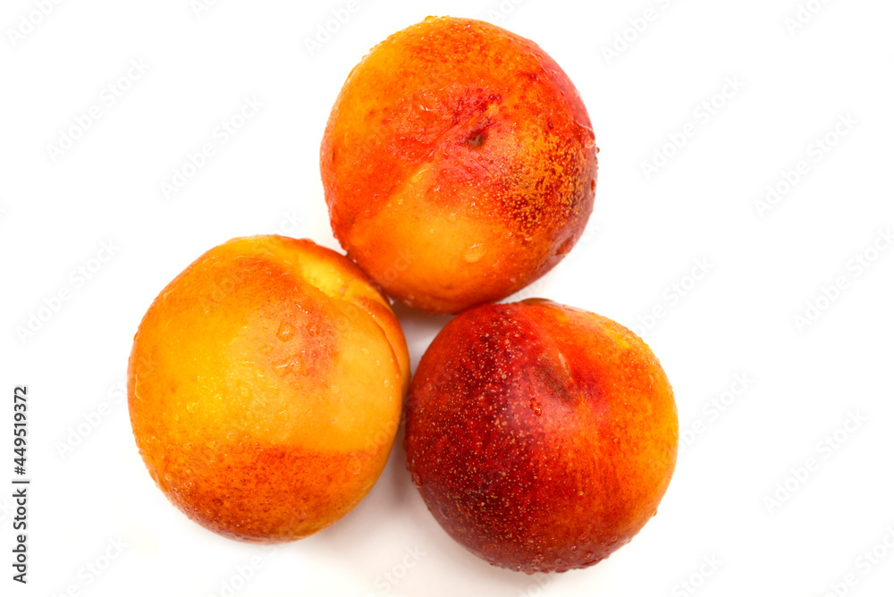 ripe yellow apricots with water drops on white background ripe yellow apricots with water drops on white background