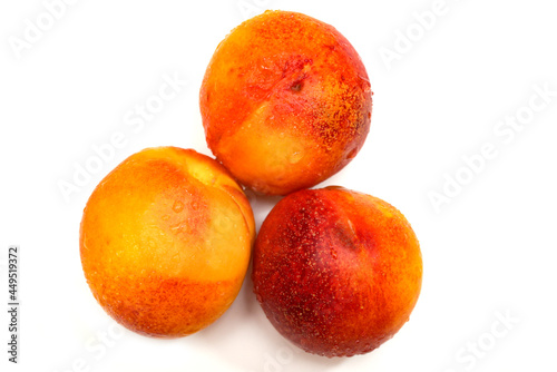 ripe yellow apricots with water drops on white background 