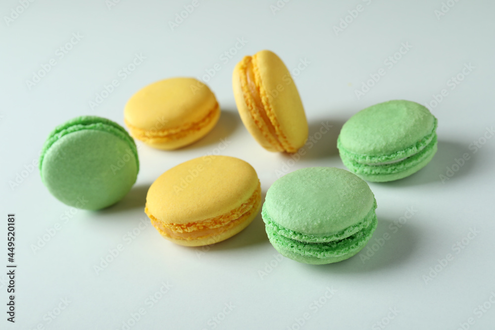 Concept of tasty dessert with macaroons on white background Concept of tasty dessert with macaroons on white background