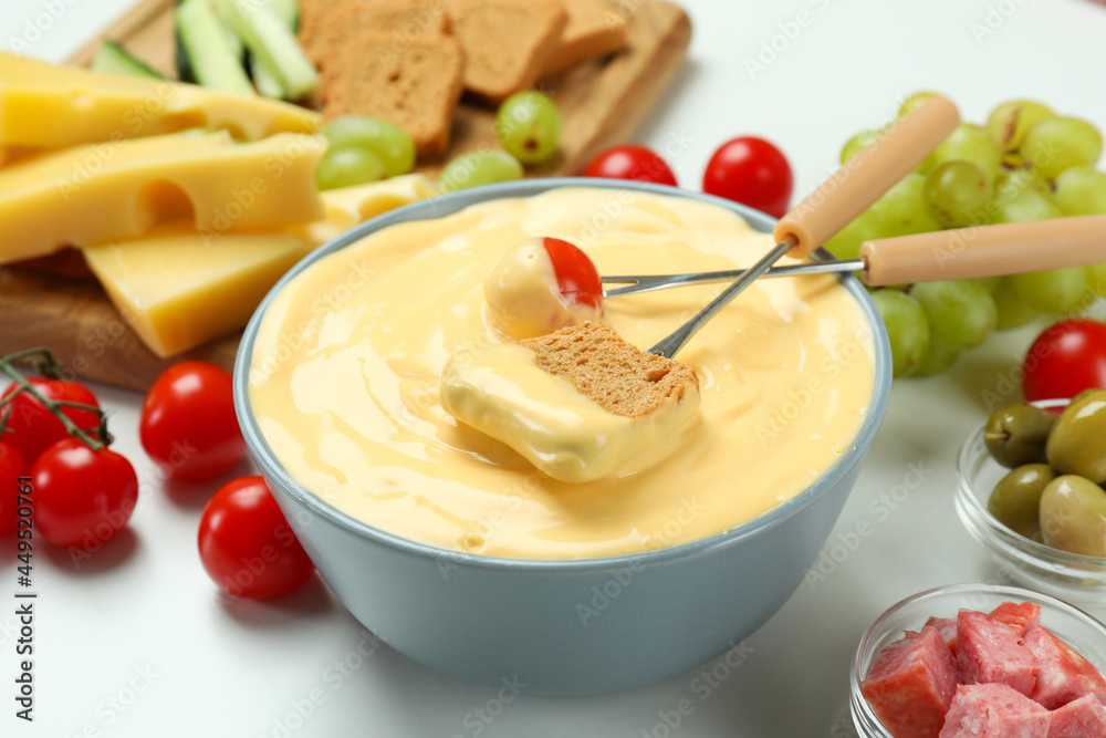 Concept of delicious food with fondue on white background Concept of delicious food with fondue on white background