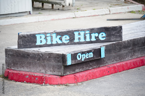 Fototapeta Bike hire sign open for business during summer