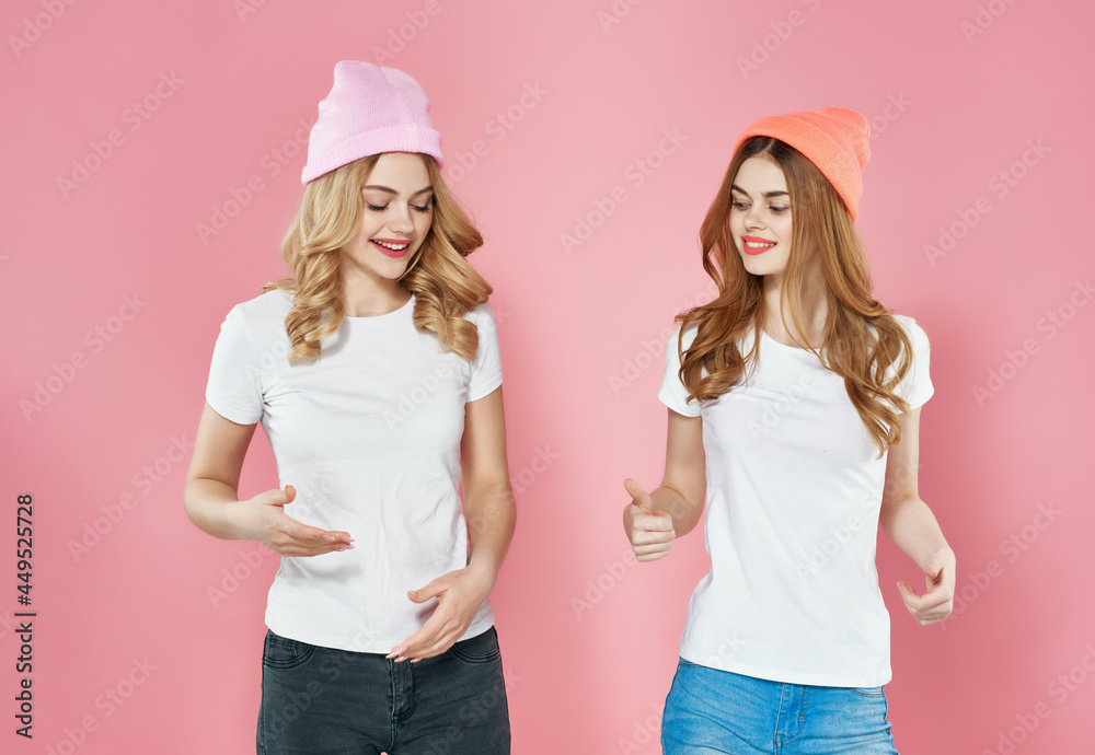 modern girlfriends in trendy clothes street style pink background