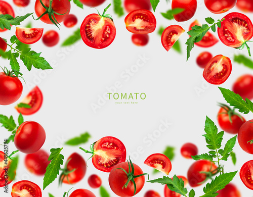 Creative food concept. Flying red ripe juicy tomatoes and green leaves on gray background. Healthy vegan organic food  vegetable  cherry tomatoes  summer  harvesting. Tomatoes pattern