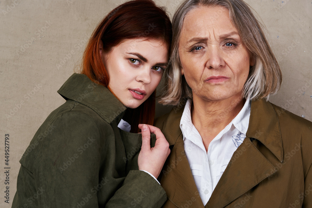 Mom and daughter in autumn coat fashion posing lifestyle Mom and daughter in autumn coat fashion posing lifestyle