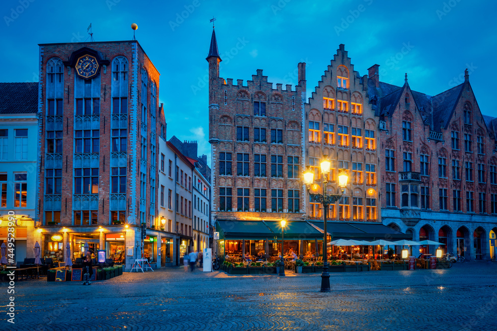 Bruges Grote markt square with cafe and restaurants in the evening night twilight