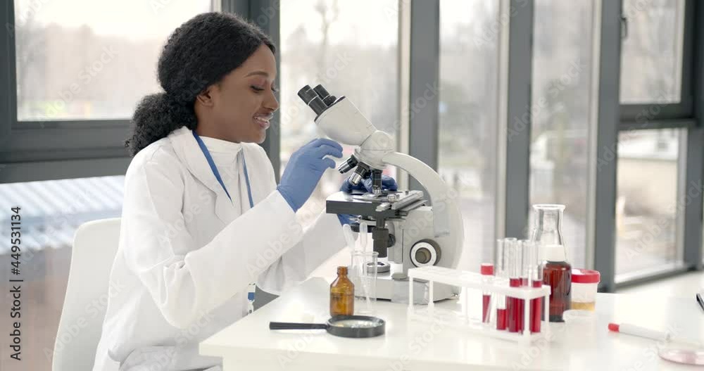 Female Scientist Working in The Laboratory Using a Microscope Female Scientist Working in The Laboratory Using a Microscope