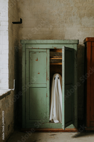 little ghost standing in the closet. Autumn halloween