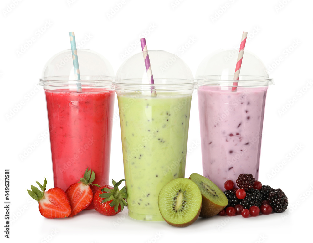 Different smoothies with straws in plastic cups and fresh fruits on white  background Photos | Adobe Stock