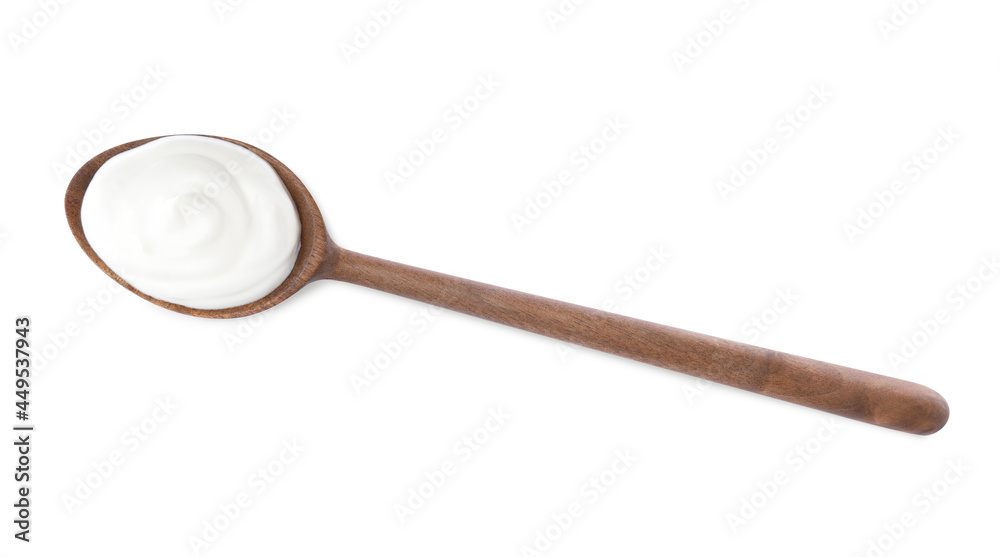 Delicious sour cream in wooden spoon on white background, top view
