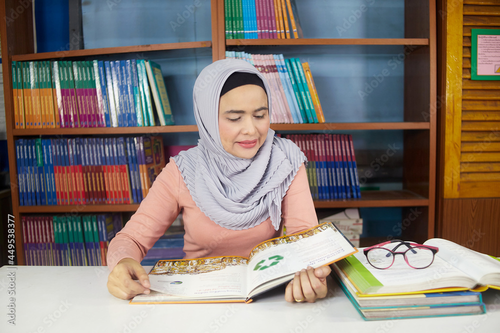 islamic woman reading  book in workroom