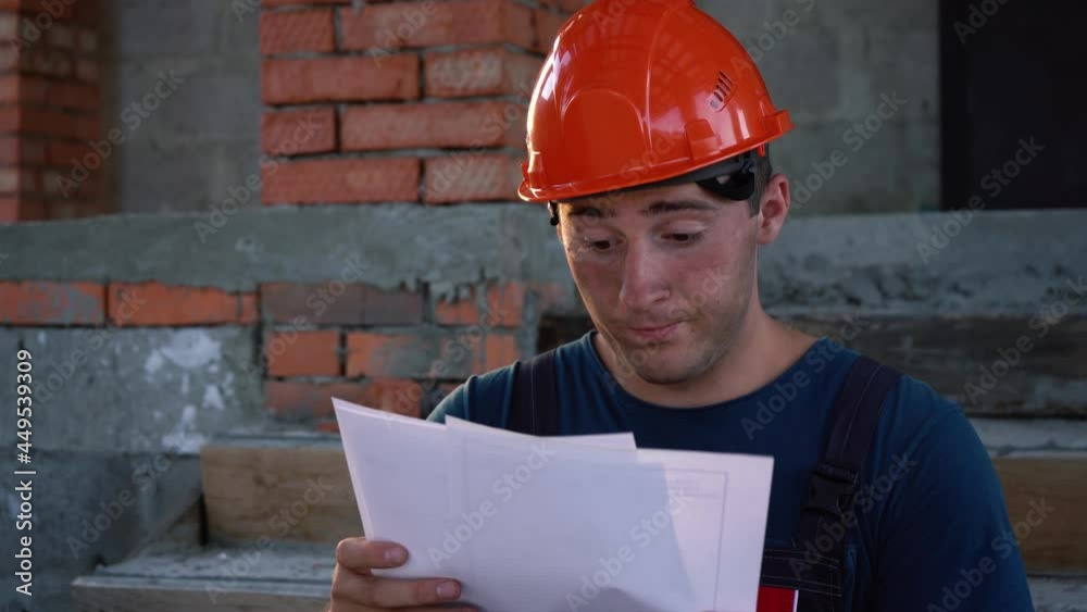 builder is looking at a construction plan