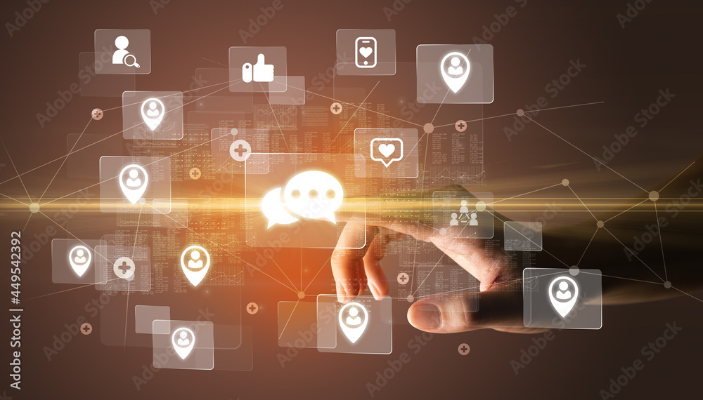 Hand pressing social media multimedia application screen with media icons on futuristic concept Hand pressing social media multimedia application screen with media icons on futuristic concept