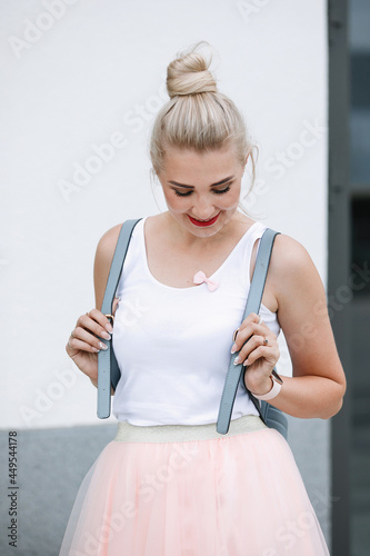 Blonde woman posing on city street
