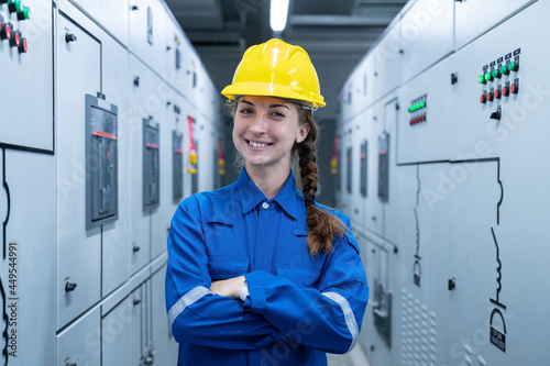 Woman Electrical Engineer working front HVAC control panels, Technician daily check solar cell controls system for security functions in service room at factory.Energy,Ventilation,Air Conditioning. 