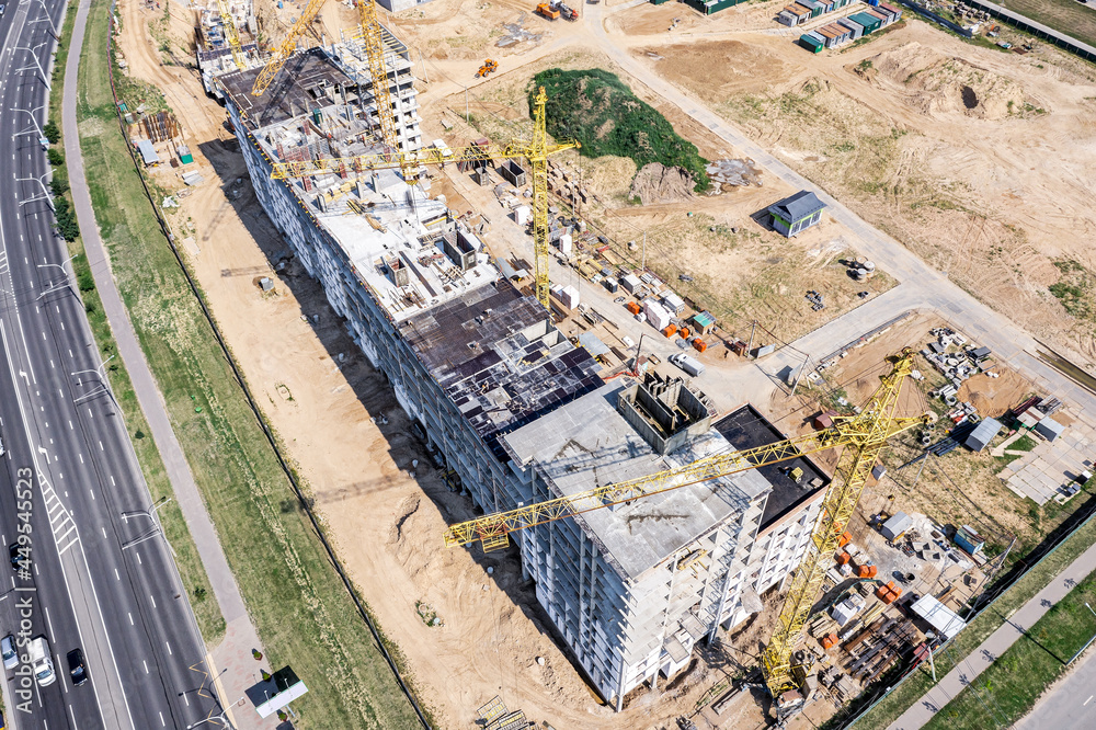 Fototapeta premium construction of new high-rise apartment building in urban residential district. birds eyes view