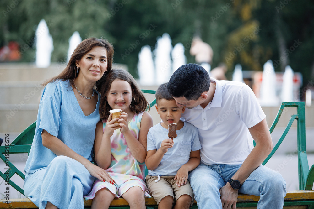 Family on a bench in the summer park Family on a bench in the summer park
