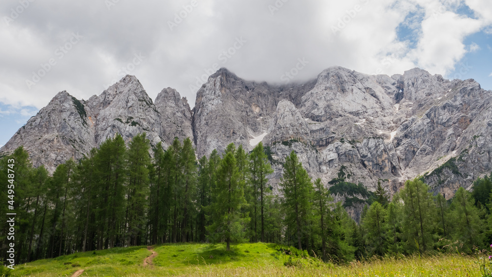 Amazing view of the Julian Alps covered with clouds.