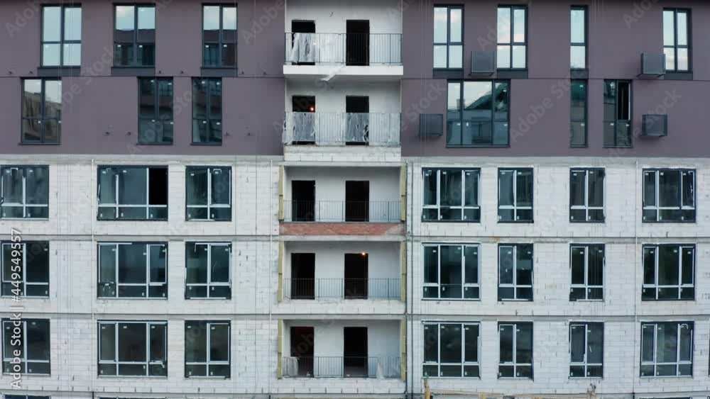 The corner of a big construction site with a houses in a course of building The corner of a big construction site with a houses in a course of building