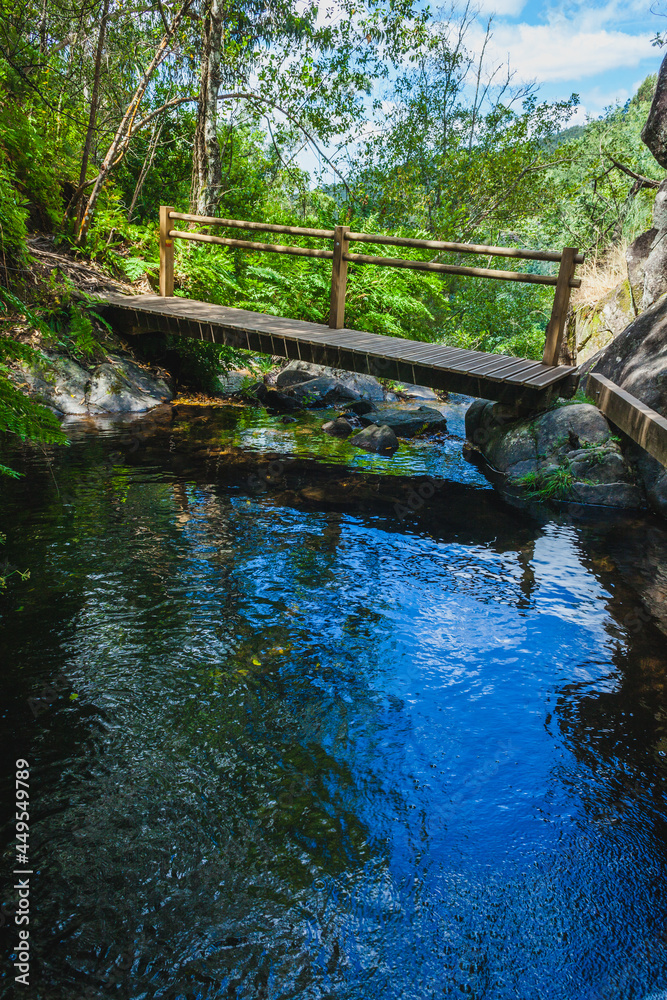 wooden bridge through on a small mountain river wooden bridge through on a small mountain river
