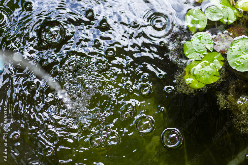 Air bubbles on the water surface in the fish pond from filling with