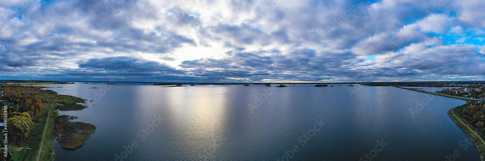 Clouds over the lake panorama aerial. Evening landscape aerial. Aerial panorama. Clouds on the river in the evening.