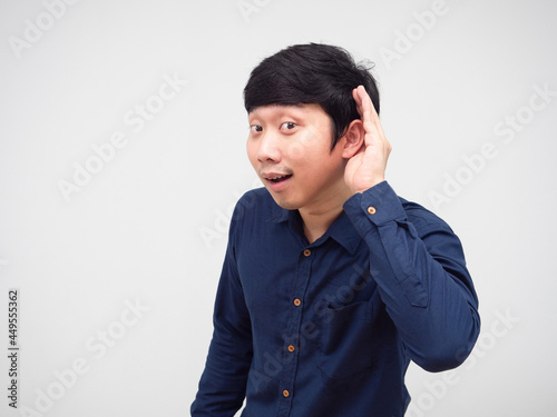 Asian man posing listening something hand up at his ear white background