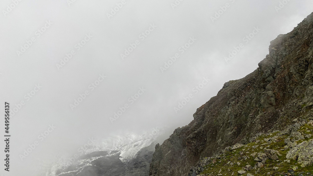 Fog in the mountains. Majestic beautiful mountains and rocks. Climbing Kazbek from the north