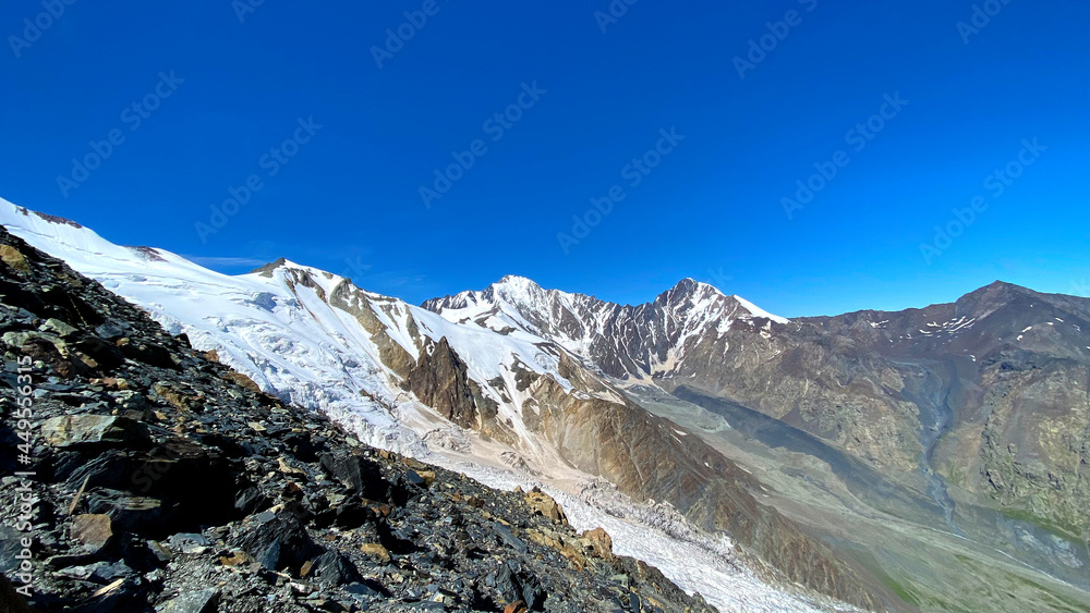 Hike across the Caucasus. Snow-capped mountains and inaccessible rocks. Mountain landscape of North Ossetia.