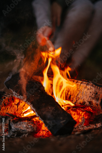 Close-up of a fire and coals in the night forest. Hiking outdoor recreation.