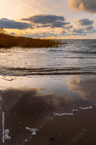 The Baltic Sea during a windy day. Waves crashing against the shore and sky reflection in the water.