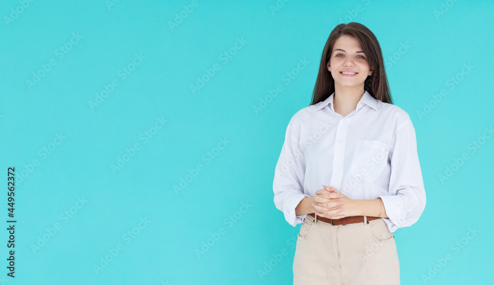 Image of happy young business woman posing isolated over blue wall background. Image of happy young business woman posing isolated over blue wall background.