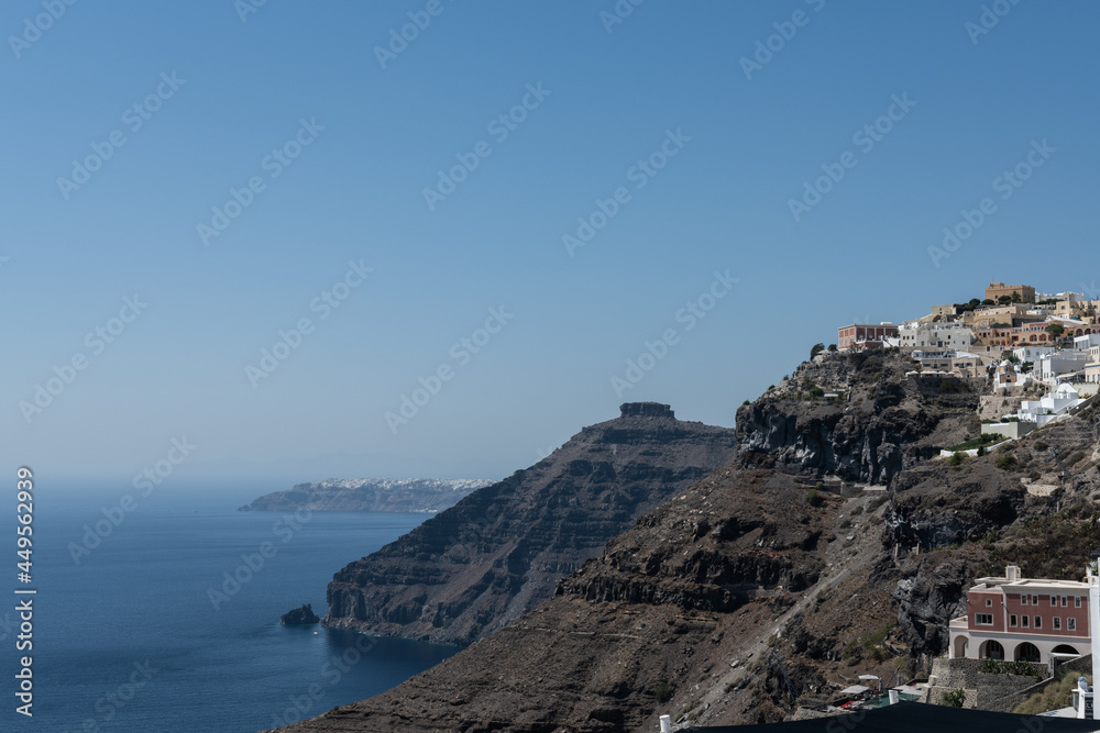 White top of buildings in Santorini, Greece with blue sky in a sunny warm day in July 2021. White top of buildings in Santorini, Greece with blue sky in a sunny warm day in July 2021.