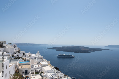White top of buildings in Santorini, Greece with blue sky in a sunny warm day in July 2021.