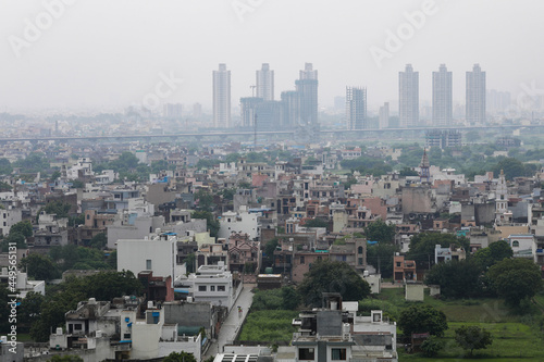 aerial landscape view of Dwarka Expressway, showing the contrast of villages and tall building.