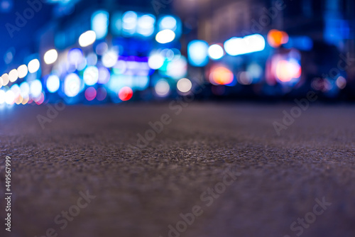 Nights lights of the big city, close up view on the road from asphalt level