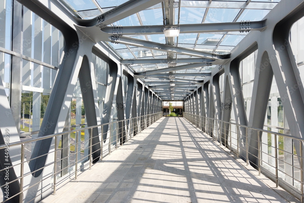 Glass pedestrian bridge with metal beams inside. Perspective perspective. Glass pedestrian bridge with metal beams inside. Perspective perspective.