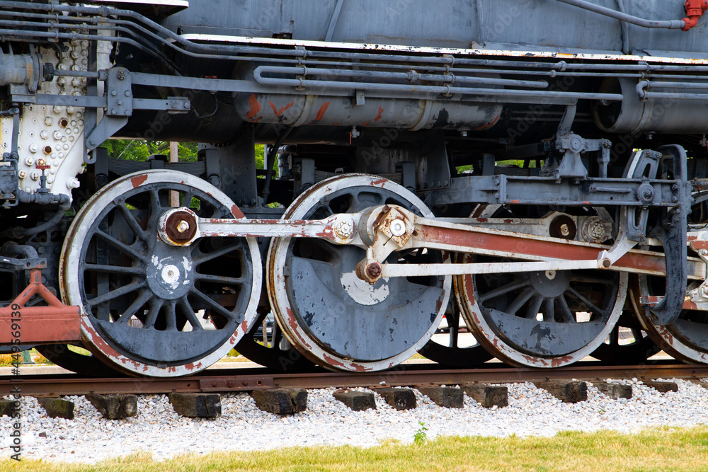 Naklejka premium A vintage set of train wheels and gears on a train track