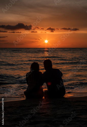 shape of a couple on the beach at sunset