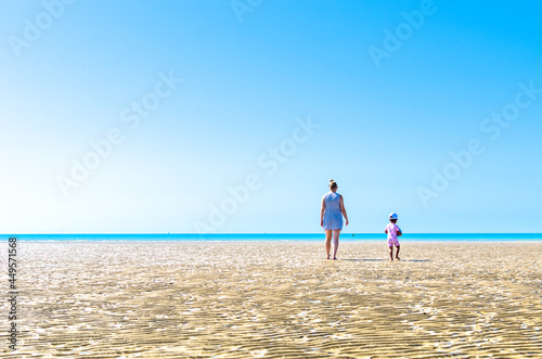 Mother and child at Camber Sands beach in summer, East Sussex, England photo