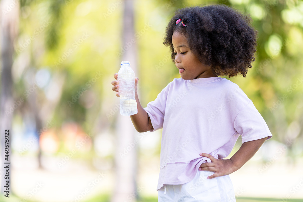 Concept of childhood and drinking water on a hot day. Concept of childhood and drinking water on a hot day.