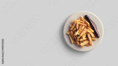 French fries in a plate on a grey background. close-up view.