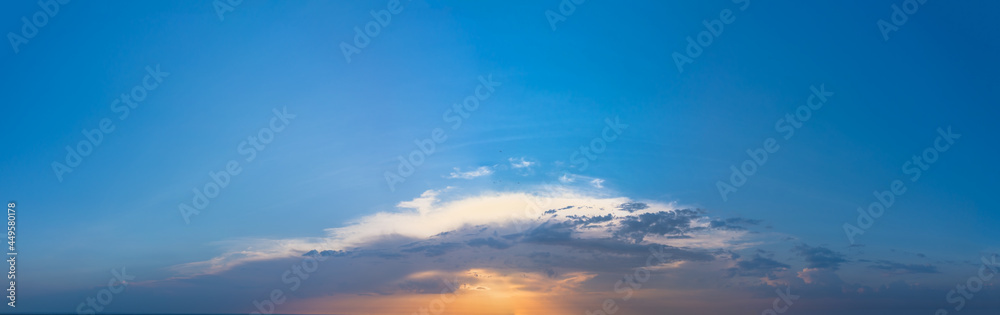 Wide angle panorama of Blue Morning Sky with glare of the Sun. Wide morning panorama of rising Sun at Dawn.