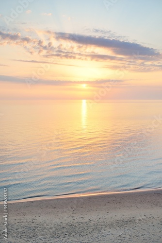 Fototapeta Naklejka Na Ścianę i Meble -  Panoramic aerial view from the Baltic sea shore after the storm. Clear sunset sky, reflections, still water surface texture. Nature, environment. Idyllic dreamlike seascape