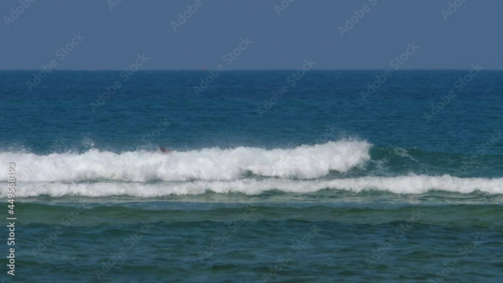 Surfer falls on a strong wave Surfer falls on a strong wave