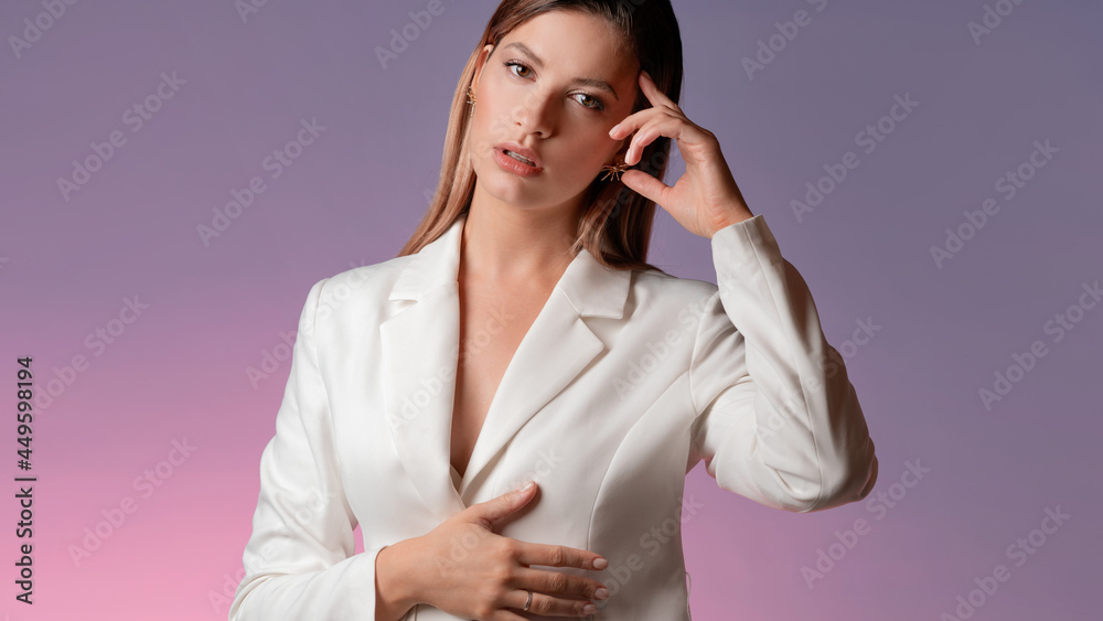 stylish young woman in a trendy white jacket looks thoughtfully at the camera, stylish young woman in a trendy white jacket looks thoughtfully at the camera,